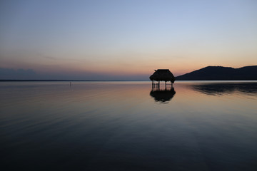 Overwater Hut and Sunset - Lake Peten Itza in Guatemala