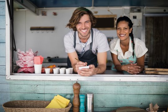Portrait of waiter and waitress smiling