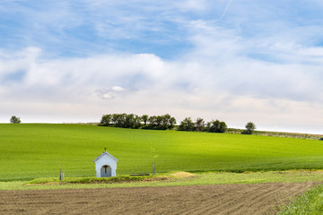 Small chapel in the middle of wavy fields