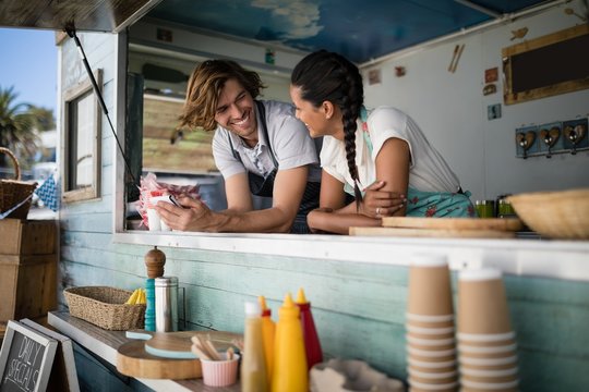 Waiter and waitress interacting with each other