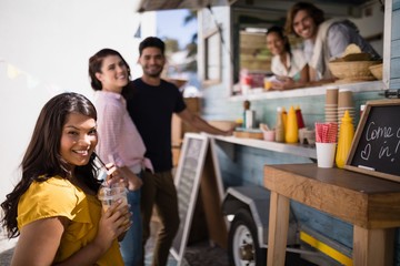 Portrait of friends smiling at counter
