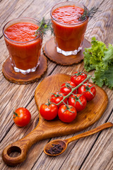 fresh tomato juice and Tomato branch on a wooden cutting board