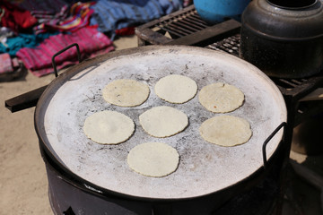 Baking tortillas on the fire - guatemalan pupusas