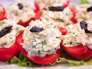 Stuffed tomatoes with cheese and garlic. Top with canned plum.