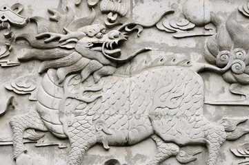 A chinese mythical creature called a kylin on a wall within Shanghai China.