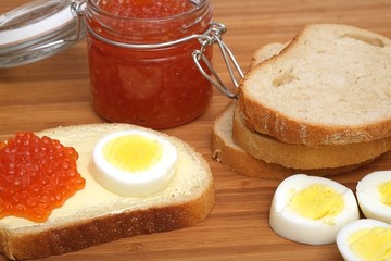 Sandwich with red caviar and egg in various angles