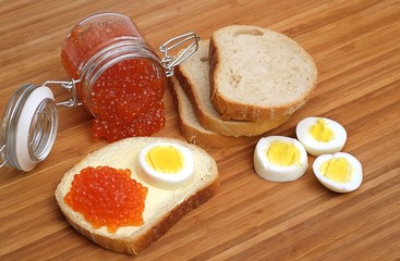 Sandwich with red caviar and egg in various angles