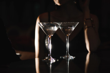 Two glasses of martini coctail in a bar