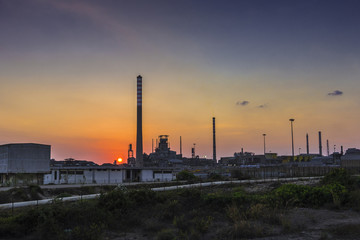 Fototapeta na wymiar Portovesme power plant at sunset, Sardinia, Italy