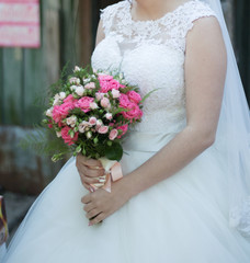 Obraz na płótnie Canvas The bride with a wedding bouquet
