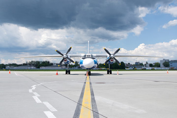 Twin engine propeller plane before thunderstorm