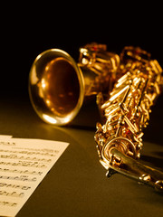 Golden saxophone on dark background.