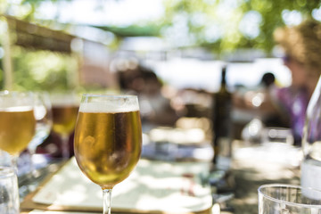 Fresh blond beer on an outdoor party close up