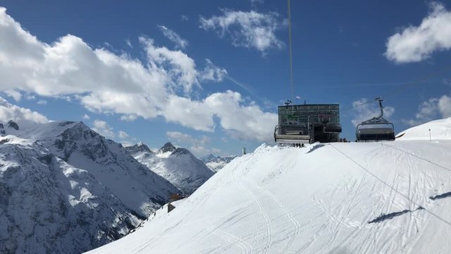 People are riding in chair lift in a ski area. Lech, Austria