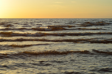 Waves with golden light on the sea. - 162770214