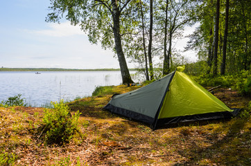 Overnight in a green tent near lake in forest. - 162770257