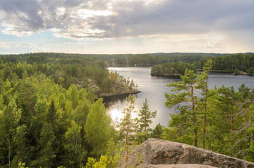 View from cliff over forest and lake. Finland. - 162770272