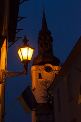 Old lantern and old tower with clock in Tallin city, Estonia. - 162770284