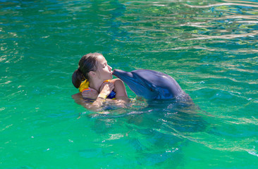Obraz premium A girl, a model swims with dolphins. Man, a mammal, a dolphin.