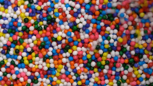 Colorful sprinkles sugar candy pouring down