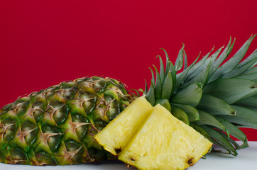 sliced pineapple fruit on red background, horizontal - 162773208