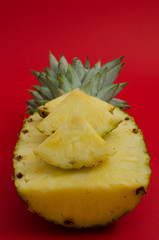 sliced pineapple fruit on red background, triangles - 162773209