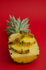 sliced pineapple fruit on red background, triangles - 162773272