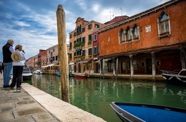 Fototapeta na wymiar Couple of retired tourists admire the beautiful Venice, Italy