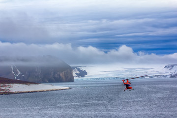 Helicopter brings scientists and extreme tourists on harsh polar Islands © max5128