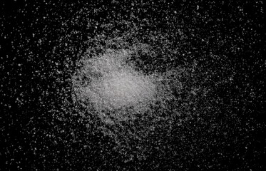 White sugar closeup isolated on black background and texture, top view