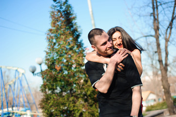 Young beautiful couple in love posing outdoor in city. Young woman smiling with her handsome man