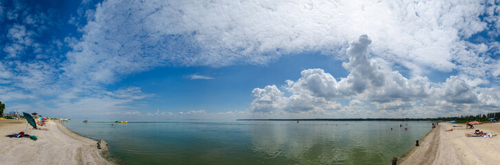 Naklejka na ściany i meble Wallpaper beautiful summer warm huge sky cloud sea beach panorama in Azov Sea