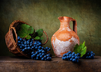 Still life with grapes on a basket and jug © Marta Teron