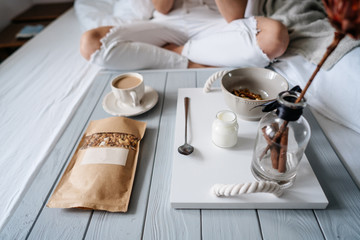 Woman eating cereals in bed