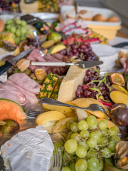 Exotic tray with fruits and cheese on table