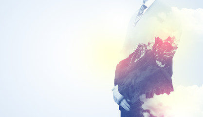 Businessman standing with mountain graphic