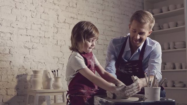 Little boy with father in pottery