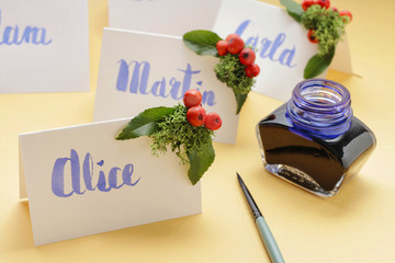 How to make wedding place name cards with handwritten letters and fresh plants - obrazy, fototapety, plakaty