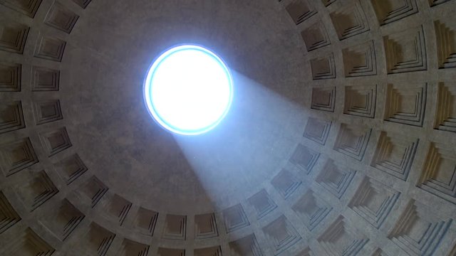 Rome Italy inside Pantheon looking up towards center of sphere hole in roof turning camera around and showing sunlight falling into temple to gods of ancient Rome now Roman Catholic church building 4k