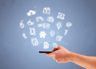 Hand holding tablet phone with drawn icons