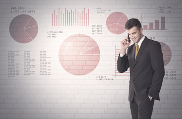 Pie charts and numbers on wall with salesman