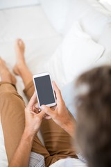 Man using mobile phone in living room