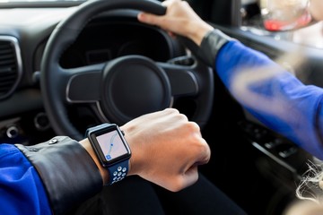 Fototapeta na wymiar High angle view of woman wearing smart watch in car