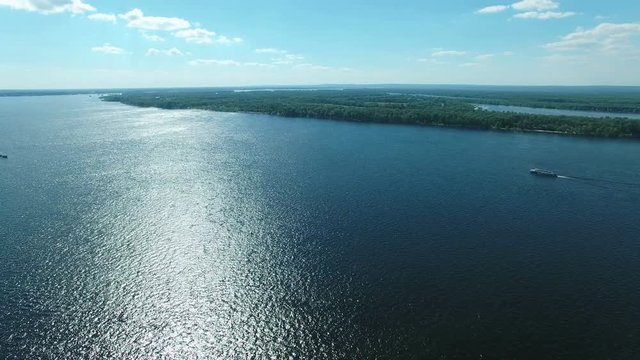 Flying over Volga river at Samara river estuary. Drone moving forward at high altitude. Aerial stock footage clip.