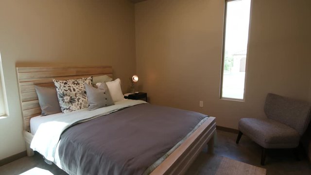 Simple Bedroom Lower Move from Ceiling Fan. shot lowers on a simple bedroom scene in a modern home

