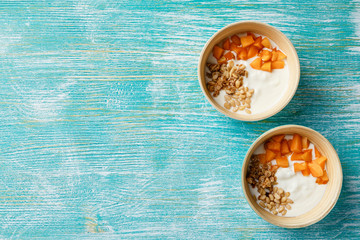 Homemade yogurt with granola, apricot and pine nuts
