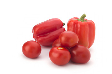 Red tomatoes and pepper on a white background