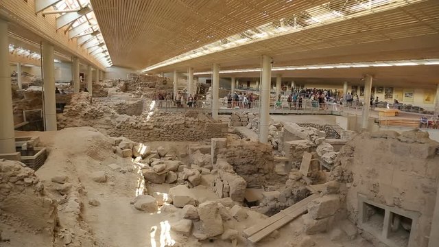 People visiting ongoing ancient Akrotiri settlement excavation site on Santorini