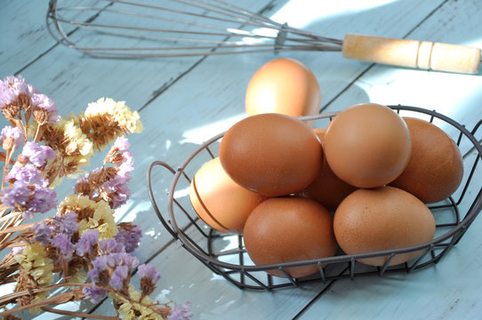 Fresh Eggs in Basket with Whisk