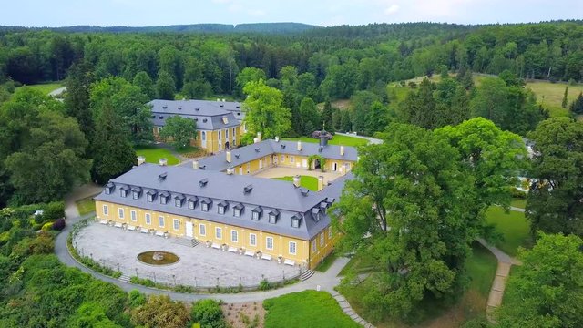 Aerial view of chateau Kozel from 18th century. Hunting castle in the classical style. Drone camera flying over cultural monument of the Czech Republic, European union.